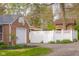 A detached garage with a basketball hoop and a white privacy fence at 3221 Washington St, Columbus, IN 47203
