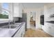 Kitchen with stainless steel sink and white cabinets, offers a view into the dining area at 3221 Washington St, Columbus, IN 47203