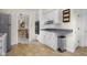 Kitchen featuring white cabinets, gas cooktop, and view of the dining area at 3221 Washington St, Columbus, IN 47203