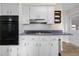 A kitchen featuring white cabinets, black oven and stovetop, and lavender colored countertops at 3221 Washington St, Columbus, IN 47203