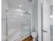 Bright bathroom featuring a shower with glass door, toilet, and neutral color palette at 326 N Warman Ave, Indianapolis, IN 46222