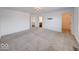 Large bedroom with neutral carpet and access to the bathroom at 326 N Warman Ave, Indianapolis, IN 46222