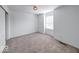 Bedroom featuring neutral carpet, white walls, and window and closet with white doors at 326 N Warman Ave, Indianapolis, IN 46222