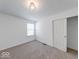 Bedroom with neutral carpet, window and closet with white doors at 326 N Warman Ave, Indianapolis, IN 46222