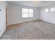 Bedroom with plush carpet, large window, and neutral paint at 326 N Warman Ave, Indianapolis, IN 46222