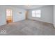 Neutral bedroom with a large window and plush carpeting at 326 N Warman Ave, Indianapolis, IN 46222