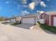 A view of two detached garages with white doors and siding complementing the main house at 326 N Warman Ave, Indianapolis, IN 46222
