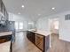 Bright kitchen with stainless steel appliances, center island, and hardwood floors at 326 N Warman Ave, Indianapolis, IN 46222