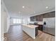 Modern kitchen featuring stainless steel appliances, dark cabinetry, and a center island at 326 N Warman Ave, Indianapolis, IN 46222