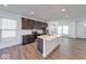 Well-lit kitchen featuring dark cabinets, stainless steel appliances, and a center island at 326 N Warman Ave, Indianapolis, IN 46222
