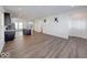 Open-concept living room featuring wood floors that flow into a modern kitchen with an island at 326 N Warman Ave, Indianapolis, IN 46222
