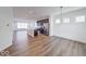 Open-concept living room with hardwood flooring, and a view into the kitchen with island at 326 N Warman Ave, Indianapolis, IN 46222