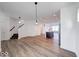 Spacious living area with hardwood floors, staircase, and an open view into the kitchen at 326 N Warman Ave, Indianapolis, IN 46222