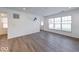 Spacious living room featuring wood floors, white walls, and lots of natural light at 326 N Warman Ave, Indianapolis, IN 46222