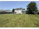 Large backyard featuring a sprawling lawn, mature trees, and partially fenced perimeter at 326 Virginia St, Fortville, IN 46040