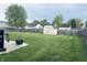 Expansive backyard with a well-maintained lawn and a storage shed at 326 Virginia St, Fortville, IN 46040