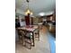 Open dining area with a wooden table set, stylish lighting, and an adjacent kitchen at 326 Virginia St, Fortville, IN 46040
