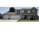 Charming two-story home with an attached two-car garage and well-maintained lawn at 326 Virginia St, Fortville, IN 46040