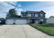 Charming two-story home with a well-manicured lawn and a spacious three-car garage at 326 Virginia St, Fortville, IN 46040