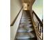 Carpeted staircase featuring wooden handrails leading to the upper level of the home at 326 Virginia St, Fortville, IN 46040