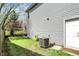 A side yard includes a fenced yard with a grass lawn, access door, and an A/C unit at 3466 Firethorn Dr, Whitestown, IN 46075