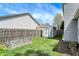 A fenced backyard includes a wooden shed, a garden plot, and lush green grass at 3466 Firethorn Dr, Whitestown, IN 46075