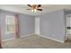 Spacious bedroom with a ceiling fan, window, and soft gray walls offers a relaxing retreat at 3466 Firethorn Dr, Whitestown, IN 46075