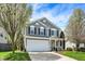 Charming two-story home featuring a well-maintained lawn, attached two-car garage, and inviting front porch at 3466 Firethorn Dr, Whitestown, IN 46075