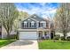 Charming two-story home featuring a well-maintained lawn, attached two-car garage, and inviting front porch at 3466 Firethorn Dr, Whitestown, IN 46075