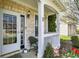 Inviting covered front porch with white railing, stone accents, and a stylish door with glass panels at 3466 Firethorn Dr, Whitestown, IN 46075