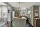 Stylish kitchen featuring modern appliances, a center island, and muted-green cabinets with dark wood floors at 3466 Firethorn Dr, Whitestown, IN 46075
