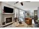 Bright living room featuring a fireplace, TV, and a glimpse into the adjacent kitchen at 3466 Firethorn Dr, Whitestown, IN 46075