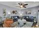 Comfortable living room featuring plush couches, stylish decor, and a ceiling fan at 3466 Firethorn Dr, Whitestown, IN 46075