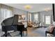 Elegant living room with a grand piano, stylish seating, and neutral decor flooded with natural light at 3466 Firethorn Dr, Whitestown, IN 46075