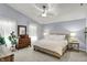Serene main bedroom features a ceiling fan and natural light with a dresser and accents at 3466 Firethorn Dr, Whitestown, IN 46075