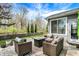 Inviting outdoor patio with wicker furniture, a fire pit table, and manicured landscaping at 3466 Firethorn Dr, Whitestown, IN 46075