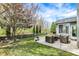 Relaxing patio with wicker furniture, a fire pit, and a beautifully maintained backyard at 3466 Firethorn Dr, Whitestown, IN 46075