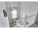 Bright staircase featuring a white railing, carpeted steps, and a window at 3466 Firethorn Dr, Whitestown, IN 46075