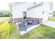 Backyard patio area with outdoor seating next to the white vinyl sided home at 360 Lincoln W Cir, Fortville, IN 46040