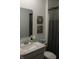 Bathroom with modern artwork, vanity with granite sink, toilet, and shower with patterned curtain at 360 Lincoln W Cir, Fortville, IN 46040