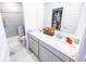 Bathroom featuring a double vanity, spacious closet, and a walk-in shower with tiled walls at 360 Lincoln W Cir, Fortville, IN 46040
