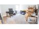 Bright bedroom that has desk, chair, and entertainment stand that is surrounded by boxes at 360 Lincoln W Cir, Fortville, IN 46040