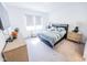 Sunlit bedroom showcasing a queen-size bed with stylish bedding, dresser, and a cozy window seat at 360 Lincoln W Cir, Fortville, IN 46040