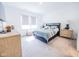 Bright bedroom with a queen-size bed, light wood furniture, and large windows for natural light at 360 Lincoln W Cir, Fortville, IN 46040