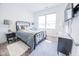 Bright bedroom features metal frame bed, modern lamps, and wall-mounted television for comfortable living at 360 Lincoln W Cir, Fortville, IN 46040
