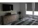 This modern bedroom has neutral tones and contains a TV above a dresser for easy viewing at 360 Lincoln W Cir, Fortville, IN 46040