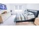 Comfortable bedroom with a queen-sized bed, light wood dresser, and a wall-mounted flatscreen TV at 360 Lincoln W Cir, Fortville, IN 46040