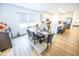 Well-lit dining room with a dark wood table, seating for six, and an open view to the kitchen at 360 Lincoln W Cir, Fortville, IN 46040