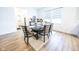 Dining area with a dark wood table, upholstered chairs, and natural light from large windows at 360 Lincoln W Cir, Fortville, IN 46040