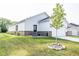 Home exterior showing a large manicured lawn with garage, backyard patio and tree at 360 Lincoln W Cir, Fortville, IN 46040